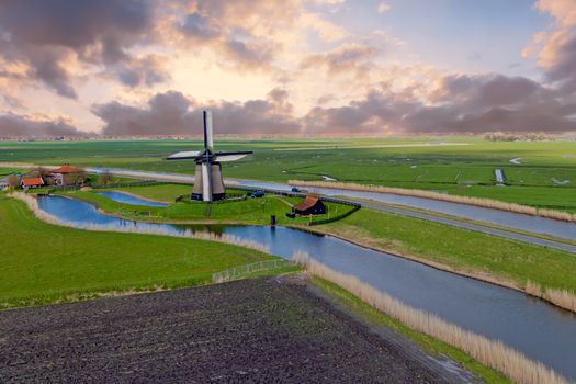 Traditional windmill in a dutch landscape in the Netherlands