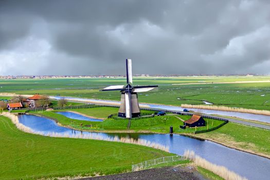 Traditional windmill in a dutch landscape in the Netherlands