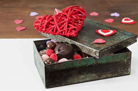 Sweets and decorative hearts for Valentine's Day heart in the old box. Selective focus.