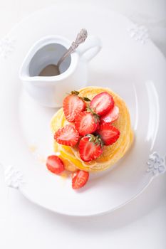 Stack of sweet pancakes with strawberry and honey. Gluten free flour.