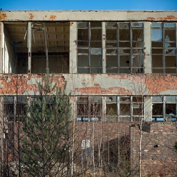 discarded ruin with old windows and wall, industrial window in concrete wall