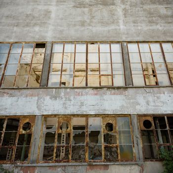 discarded ruin with old windows and wall, industrial window in concrete wall