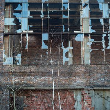 discarded ruin with old windows and wall, industrial window in concrete wall