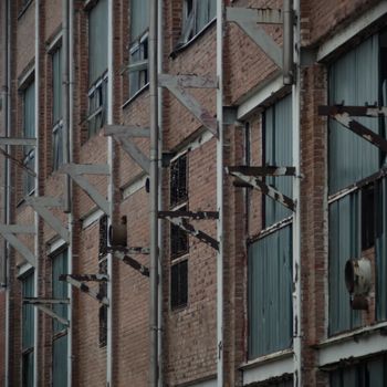 discarded ruin with old windows and wall, industrial window in concrete wall