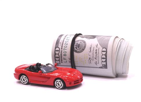 One hundred dollars banknotes and a red sports car