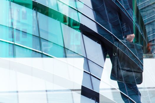 Abstract double exposure of businessman and office buildings, rush hours concept