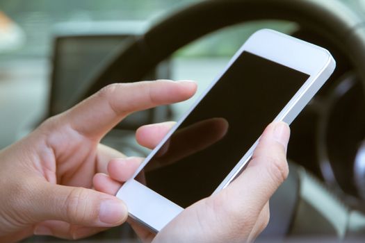 image of using a mobile phone inside of a car. communication networking