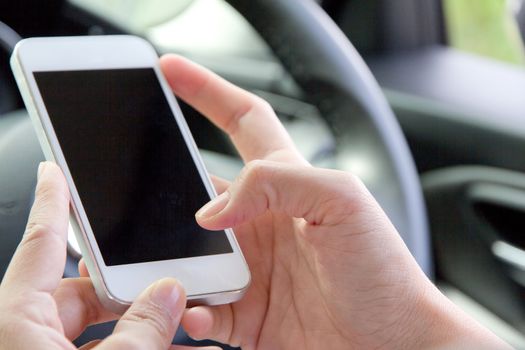 image of using a mobile phone inside of a car. communication networking