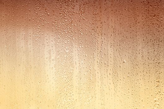 Background with drops on glass, stained yellow-brown. Plenty of space for text.