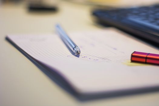 pen on a sheet, close-up with shallow DOF