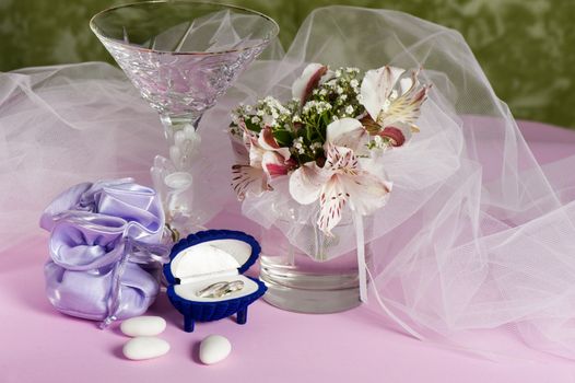  wedding rings and wedding favors on a colorful background