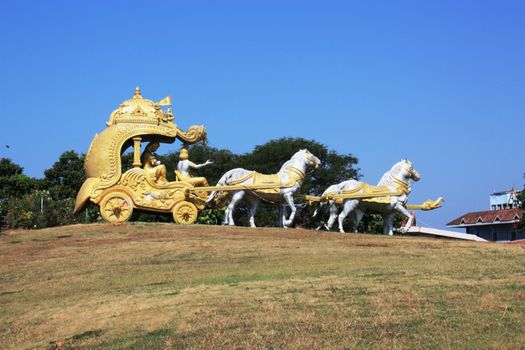 Golden carriage with white horses in the temple complex Murudeshwar