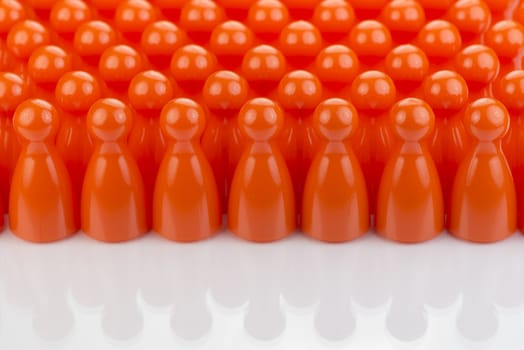 Conceptual orange game pawns as abstract view of a crowd
