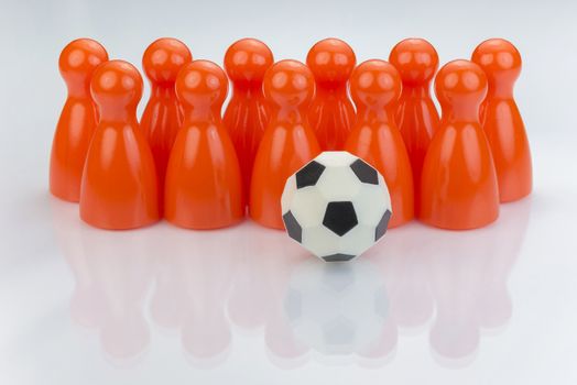 Conceptual orange game pawns as abstract view of a national football team
