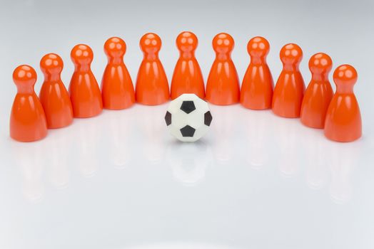 Conceptual orange game pawns as abstract view of a national football team
