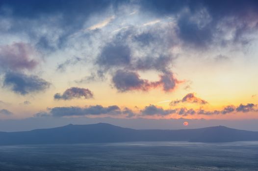 Dramatic colorful sunset at Santorini, Greece. View to caldera sea.