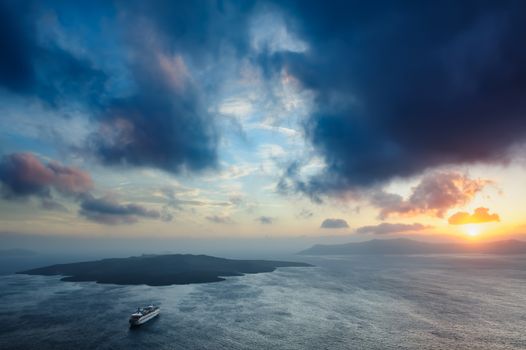 Dramatic colorful sunset at Santorini, Greece. View to caldera sea.