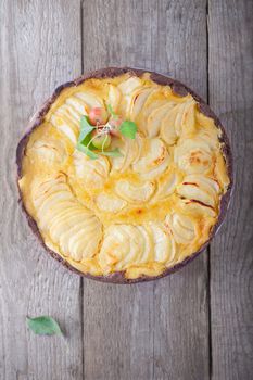 Apple pie with custard on wooden table. Gluten free.