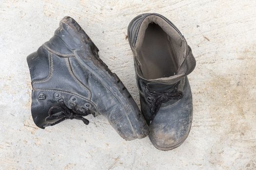 Safety leather man shoe on the cement floor texture background