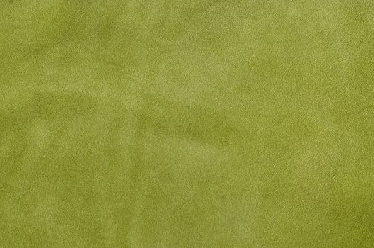 Green suede soft leather as texture background. Close up shammy leather texture