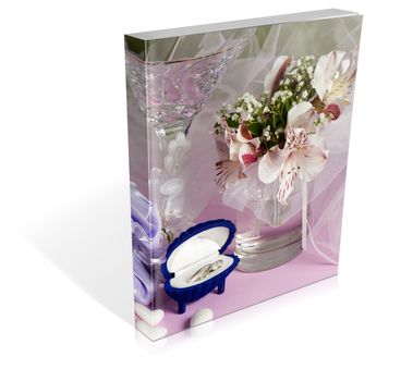 book of  wedding rings and wedding favors on a colorful background