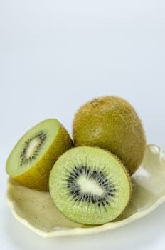 fresh ripe green  kiwi fruit onc plate