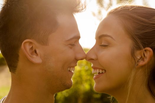 Portrait of a happy young couple in love and giving a kiss