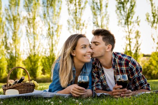 Shot of a beautiful couple in love making a picnic on the park