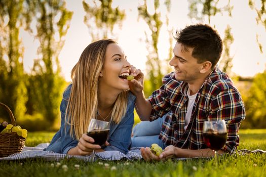 Shot of a happy couple enjoying a day in the park making a picnic