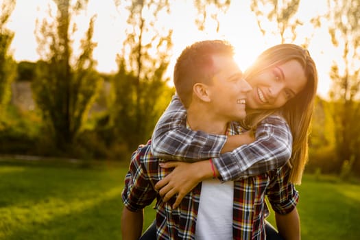 Portrait of a happy young couple in the nature hugged together