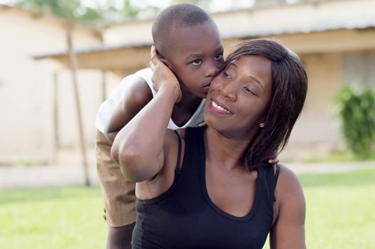 This woman is very proud of her child and she asks him to give her a kiss.