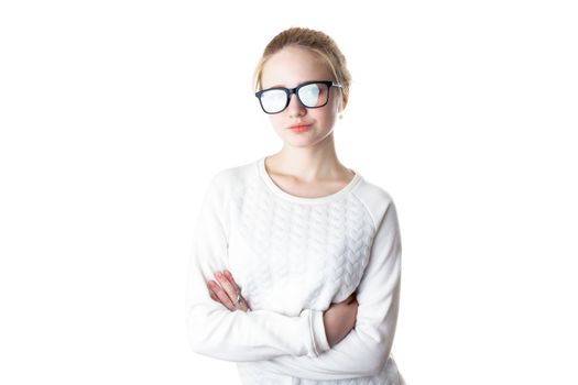 Girl teenager in glasses with flare effect. Young woman in glasses and a white sweater, crossed her arms and smiles. Isolated on white background