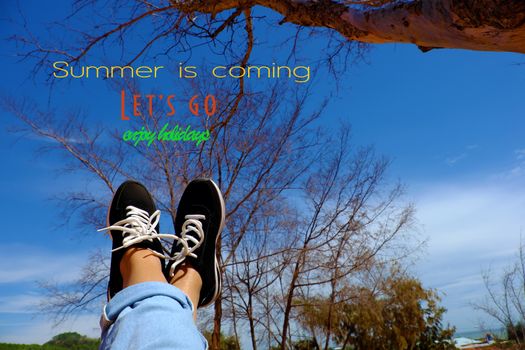 Girl travel alone and enjoy summertime by raise legs up to sky, people relax under tree to happy summer holiday