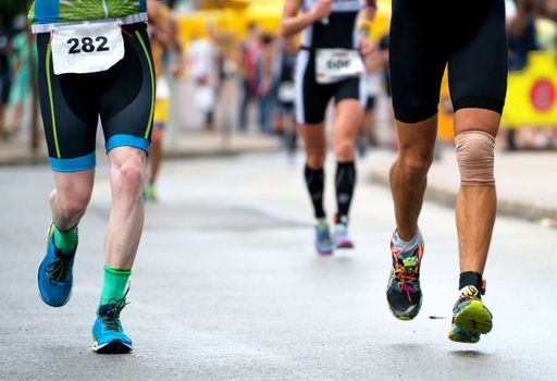 Group of marathon runners on the street.