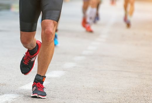 Group of marathon runners on the street.