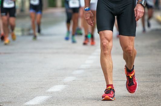 Racewalking. Tired marathon runner on the street.