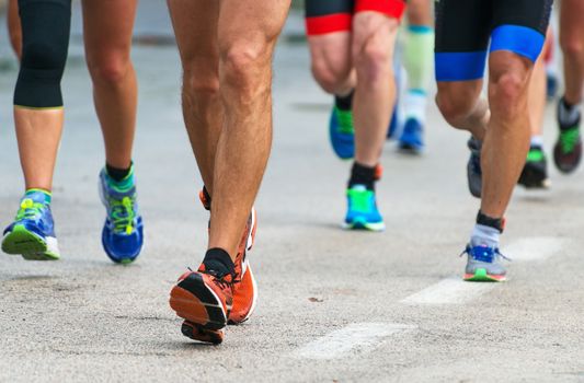 Group of marathon runners on the street.