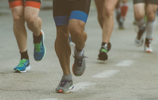 Group of marathon runners on the street.