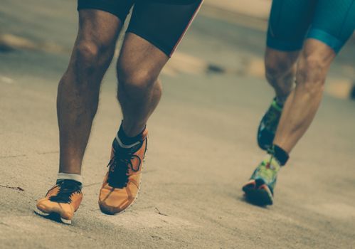 Male runners on the city road.