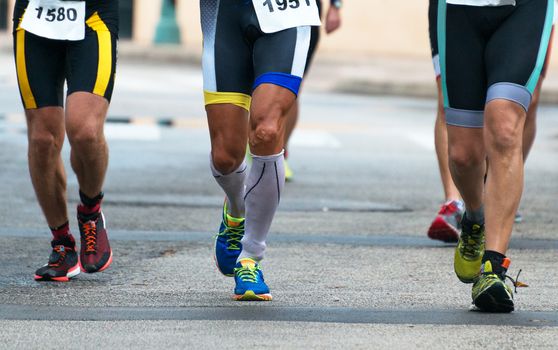 Group of marathon runners on the street.