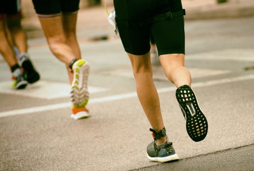 Group of marathon runners on the street.