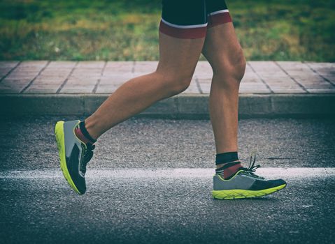 Male athlete running on the street.