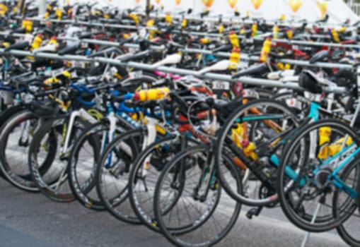Many bicycles after race on the street. Blurred image.