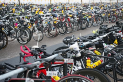 Many bicycles after race on the street. Blurred image.