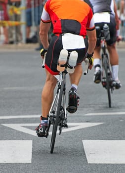 Unrecognizable professional cyclists during the bicycle competition. Back view.