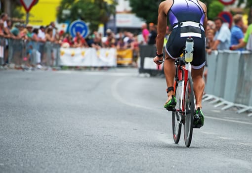 Unrecognizable professional cyclist during the bicycle competition. Back view.