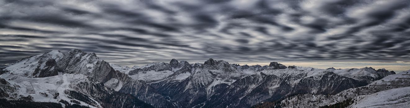 landscape from Sella pass in a winter afternoon and the wind plays with the clouds