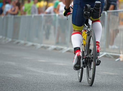 Unrecognizable professional cyclist during the bicycle competition. Back view.