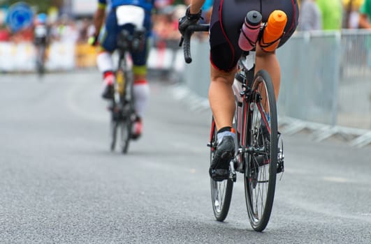 Unrecognizable professional cyclists during the bicycle competition. Back view.