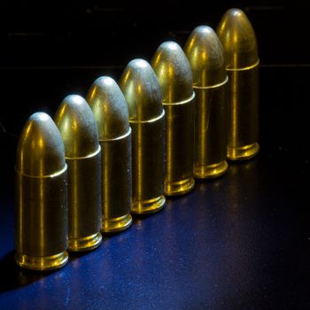 The bullets bullets lined up on black background